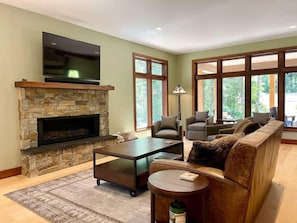 Living Area with gas fireplace, Smart TV, sitting area and views of the back yard