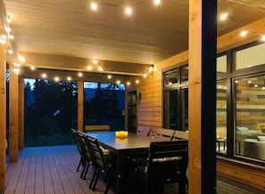 Covered back deck with dining area, with lights
