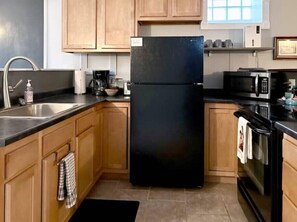 Full kitchen equipped with pots, pans, and utensils for a home cooked meal.