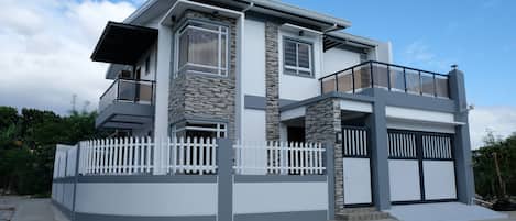 The immaculate 4 bedroom house with 3 full bathrooms, 2 balconies + gated garage
