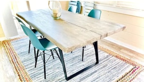 Dining room has 6 chairs (4 shown), and a long table.