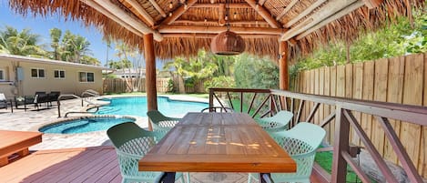 Kick back and get vacation ready! Shaded tiki hut with pool views and BBQ