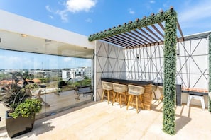 Relax on the spacious rooftop lounge area which is for common use and offers a year-round infinity pool
