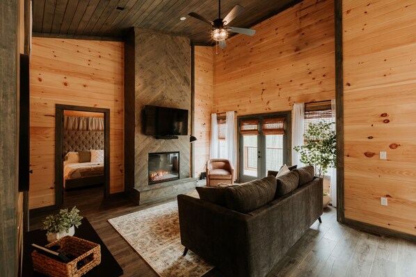 Living room with Queen pull out couch, 55" TV, gas fireplace and Sonos Sound bar