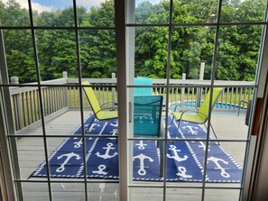 large deck with pool and forest views.