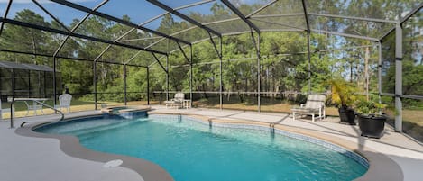 Pool overlooked wooded area