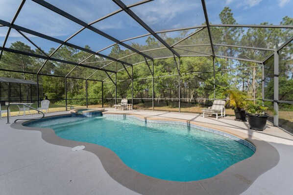 Pool overlooked wooded area