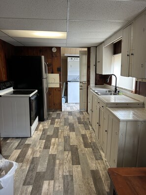 Long galley Kitchen with electric range, fridge to hold all food/beverages 