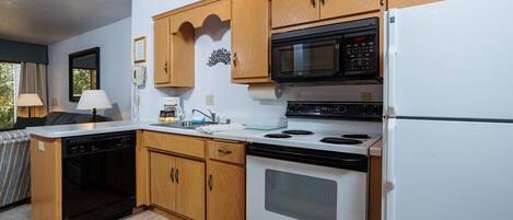 Fully stocked kitchen includes dinner and cookware, utensils and appliances