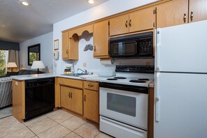 Fully stocked kitchen includes dinner and cookware, utensils and appliances