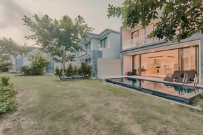 A view of Villa's exterior from the backyard, with a vista of BRG golf course. 