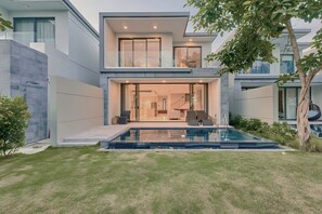 A view of Villa's exterior from the backyard, with a vista of BRG golf course. 
