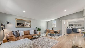 - Stretch out on the cozy leather sectional for movie nights or lazy mornings
- Share meals and laughs around the stylish woven dining chairs and sleek table
- Flow easily from living to kitchen in this bright, open concept layout