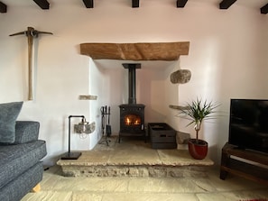 Log burner in original 18th Century fireplace