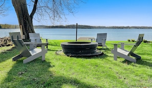 Cosy up by the fire pit, with stunning lake views.