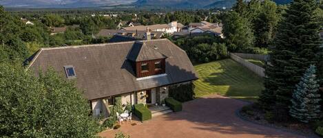 Black Grouse Lodge view of house and Cairngorm Mountains