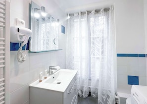 A full equipped bathroom with shower