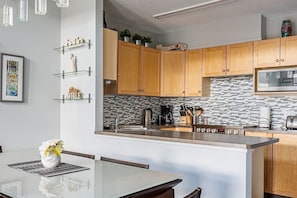 Lovely kitchen and dining area. The kitchen is fully equipped with fresh local Eclipse coffee beans, tea, and condiments