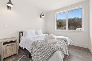 Our Primary bedroom has a Queen-size bed, a closet and an ensuite bathroom.