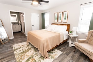 Large bedroom with sitting area and private bath and smart TV