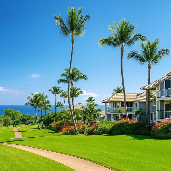 A tropical paradise unfolds along the coastline, where luxurious resort villas are nestled amid vibrant landscaping and swaying palm trees.