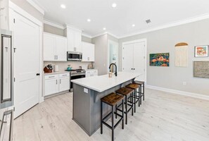 Curated artwork and kitchen island stools 
