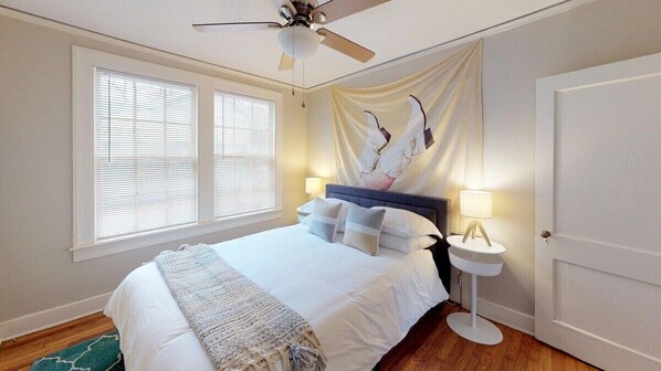 Guest Bedroom off the living room features a queen bed with safe rest encasement and fresh linens.