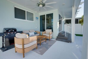 BBQ with propane tank and outdoor seating area. Great for afternoons by the pool
