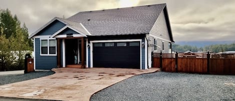 Front of the house with plenty of parking on the driveway and gravel area 