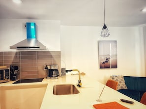 Fully-equipped kitchen with pots, pans and utensils.