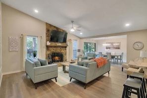 Living room with wet bar; 55" Roku TV.