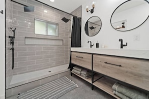 Bathroom bliss: dual showers, paired sinks, chic circular mirrors. Your aesthetic getaway for relaxation and glam!