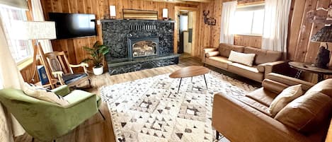 LIving room with plenty of sitting and a smart TV.