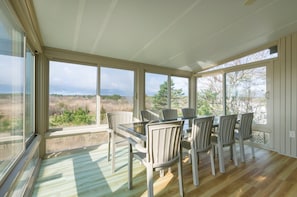 Sun room / Dining room with seating for eight guests.