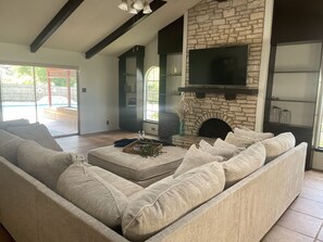 Family room opens to covered patio with glass sliders