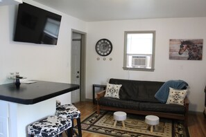 Open living room and kitchen are bright and fresh.