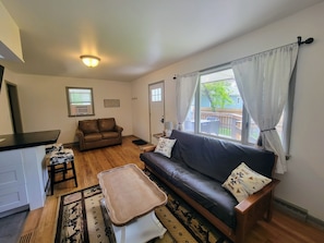 Living room with full size futon and twin sleeper