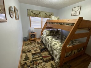 A comfortable bunk bed with full-sided lower and twin upper, room for adults too