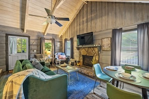 Living room, sofa bed is the green couch. Such a cozy space.