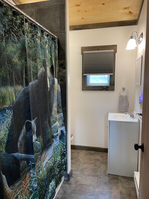 Bathroom with bathtub/shower. Towels provided.