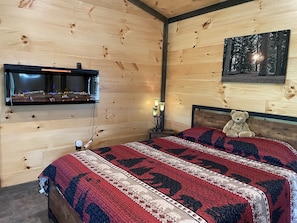 Queen. bed with wall fireplace.