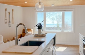 Fully equipped kitchen with views of the lake. 