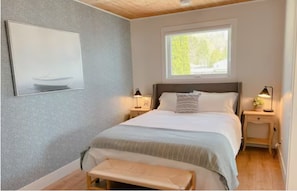 Cozy coastal bedroom with a queen bed. 