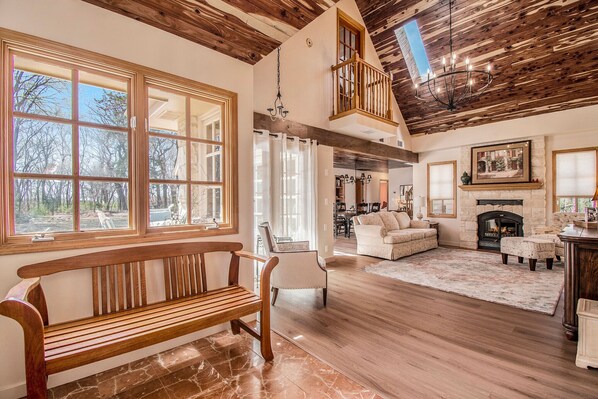 Exquisite foyer great room cathedral clgs cedar lined open and bright.
