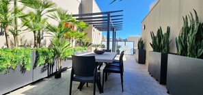 Private rooftop terrace with views, dining table and multiple seating areas