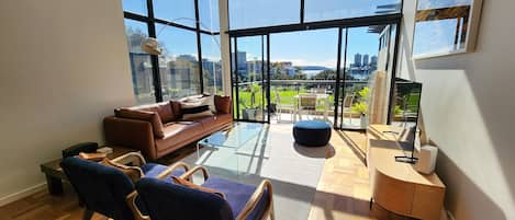 Living room, loads of natural light, views, high ceilings, balcony, air con