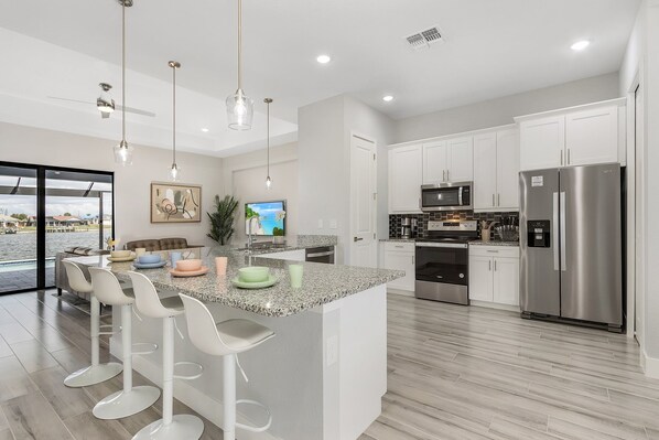 Modern kitchen with sleek appliances and spacious island for family gatherings
