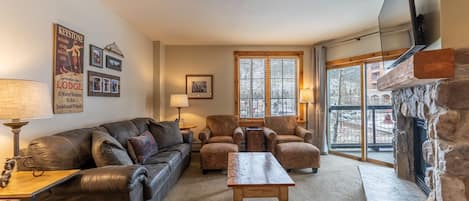 Living area offering cozy furnishings, a gas fireplace and smart TV.