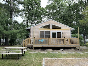 Large deck with dining for 6 and seating area, sun shade, and gas grill 