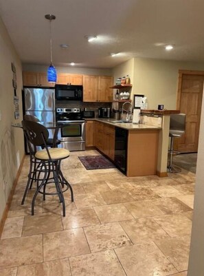 Full kitchen with Bistro table and 2 bar stools. Additional high bar w/ 2 stools